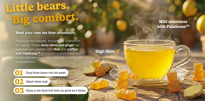 Cup of hot lemon and ginger tea surrounded by gummy bears made with Palatinose™ and fiber, promoting balanced energy, mild sweetness and a comforting tea ritual.